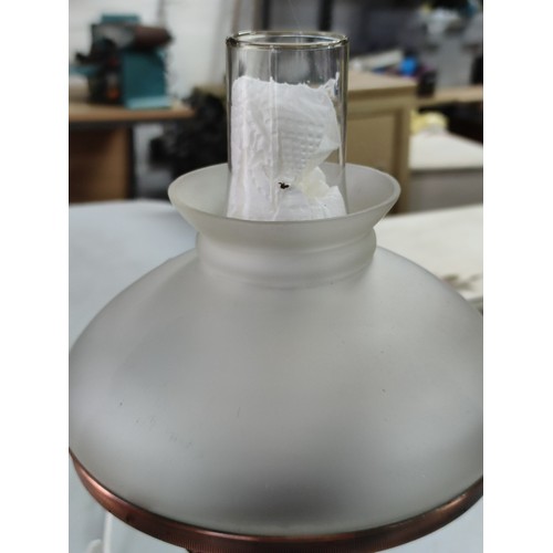 456B - Good quality brushed copper effect paraffin lamp complete with shade and chimney along with a rock c... 