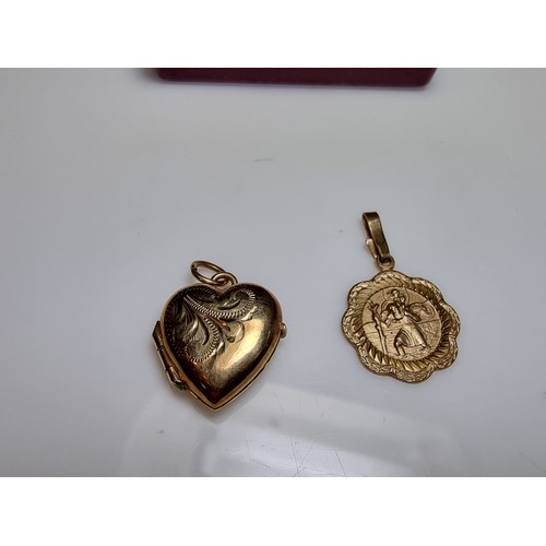 253 - 2x 9ct yellow gold hallmarked pendant to include a St Christopher pendant and a half locket pendant ... 