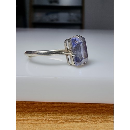 257 - A 9ct white gold ring inset with a large baquette cut genuine sapphire stone presenting an excellent... 