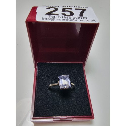 257 - A 9ct white gold ring inset with a large baquette cut genuine sapphire stone presenting an excellent... 