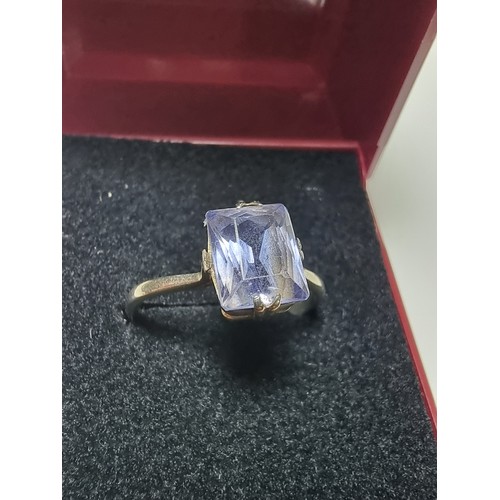 257 - A 9ct white gold ring inset with a large baquette cut genuine sapphire stone presenting an excellent... 