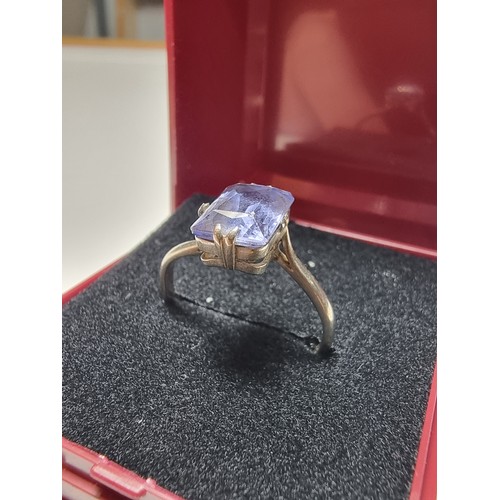 257 - A 9ct white gold ring inset with a large baquette cut genuine sapphire stone presenting an excellent... 