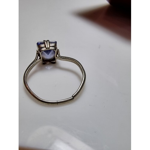 257 - A 9ct white gold ring inset with a large baquette cut genuine sapphire stone presenting an excellent... 