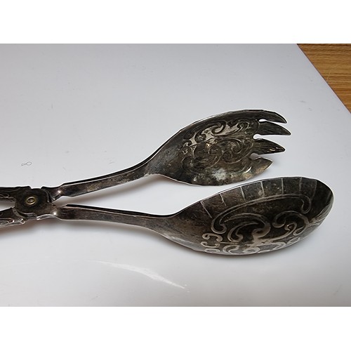 260 - A pair of good antique silver plated ornate salad tongs along with a plated napkin ring.