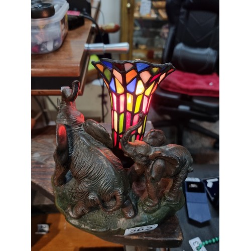 262 - A pretty resin elephant formed lamp with a stain glass shade by Widdop Bigham, signed to the rear 19... 