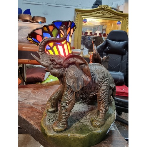 262 - A pretty resin elephant formed lamp with a stain glass shade by Widdop Bigham, signed to the rear 19... 