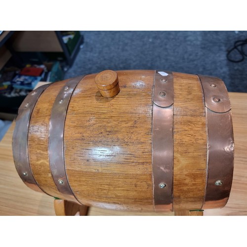 271 - A good quality vintage solid oak copper bound barrel keg on its original stand with a wooden stopper... 