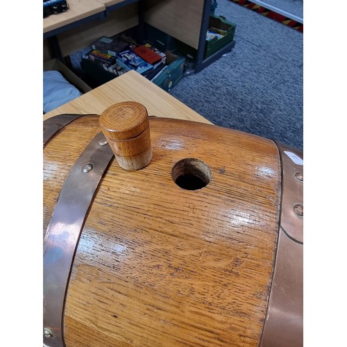 271 - A good quality vintage solid oak copper bound barrel keg on its original stand with a wooden stopper... 