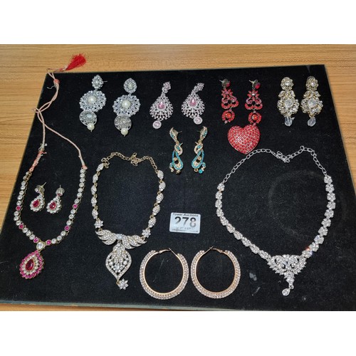 278 - A suite of as new glitzy jewelled jewellery including matching necklace and earring set with pink an... 