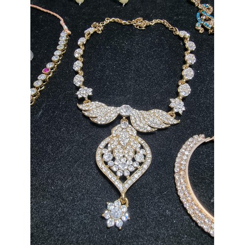 278 - A suite of as new glitzy jewelled jewellery including matching necklace and earring set with pink an... 