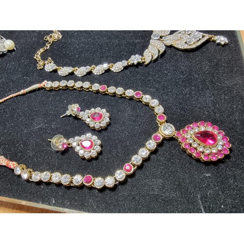 278 - A suite of as new glitzy jewelled jewellery including matching necklace and earring set with pink an... 