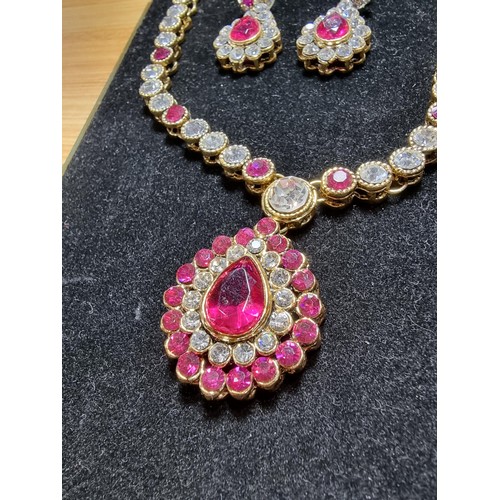 278 - A suite of as new glitzy jewelled jewellery including matching necklace and earring set with pink an... 