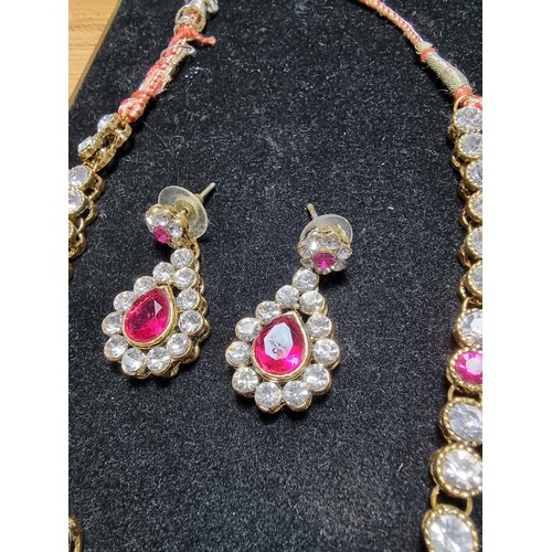 278 - A suite of as new glitzy jewelled jewellery including matching necklace and earring set with pink an... 