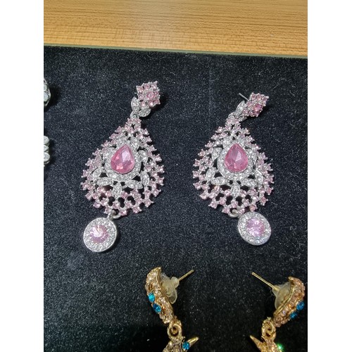 278 - A suite of as new glitzy jewelled jewellery including matching necklace and earring set with pink an... 