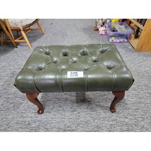 507 - Green leather buttoned footstool on cabriole legs leather in good order 
34cm by 55cm and 34cm high