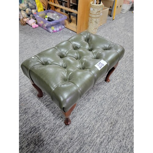 507 - Green leather buttoned footstool on cabriole legs leather in good order 
34cm by 55cm and 34cm high