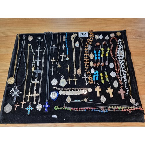 284 - A suite of various religious related jewellery to include many Crucifix's and crosses some with Rosa... 