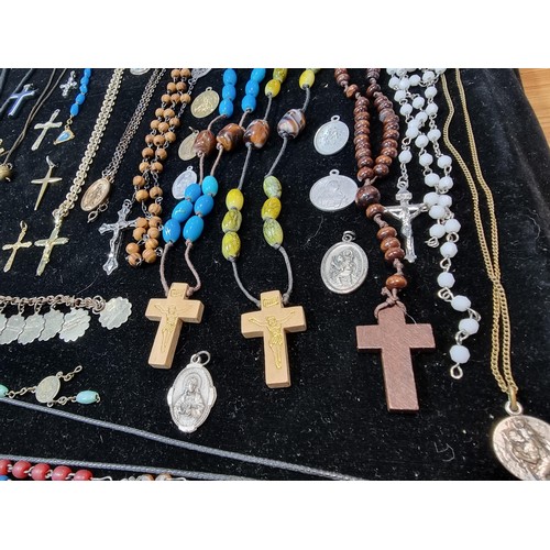 284 - A suite of various religious related jewellery to include many Crucifix's and crosses some with Rosa... 