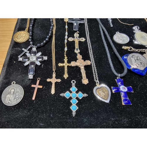 284 - A suite of various religious related jewellery to include many Crucifix's and crosses some with Rosa... 