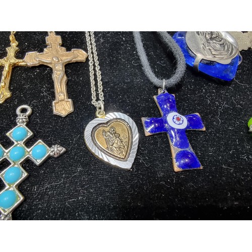 284 - A suite of various religious related jewellery to include many Crucifix's and crosses some with Rosa... 