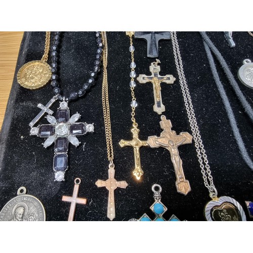 284 - A suite of various religious related jewellery to include many Crucifix's and crosses some with Rosa... 