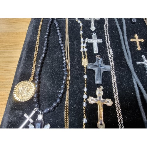 284 - A suite of various religious related jewellery to include many Crucifix's and crosses some with Rosa... 