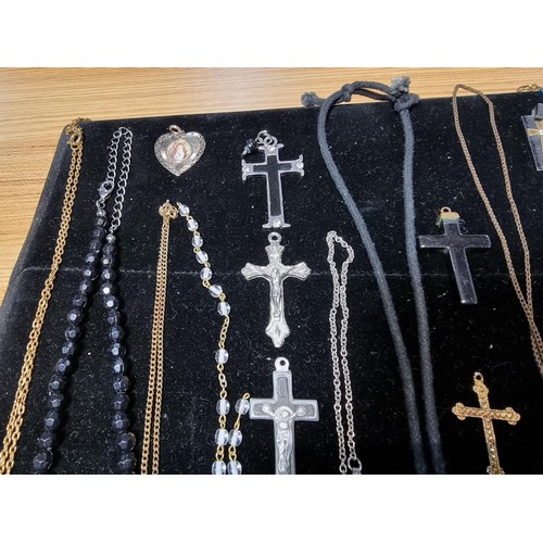 284 - A suite of various religious related jewellery to include many Crucifix's and crosses some with Rosa... 