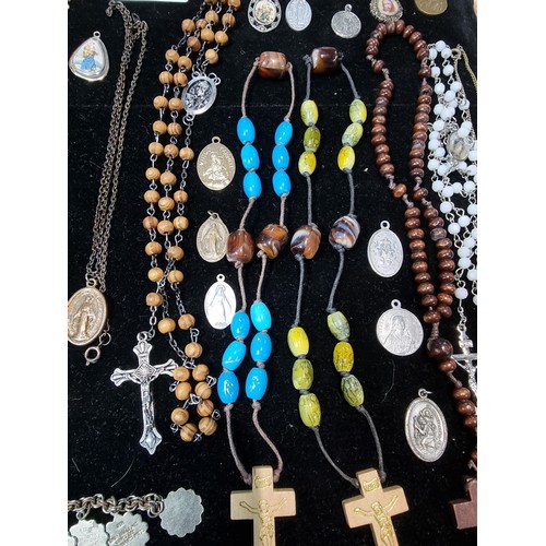 284 - A suite of various religious related jewellery to include many Crucifix's and crosses some with Rosa... 