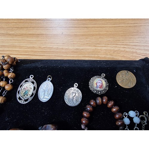 284 - A suite of various religious related jewellery to include many Crucifix's and crosses some with Rosa... 