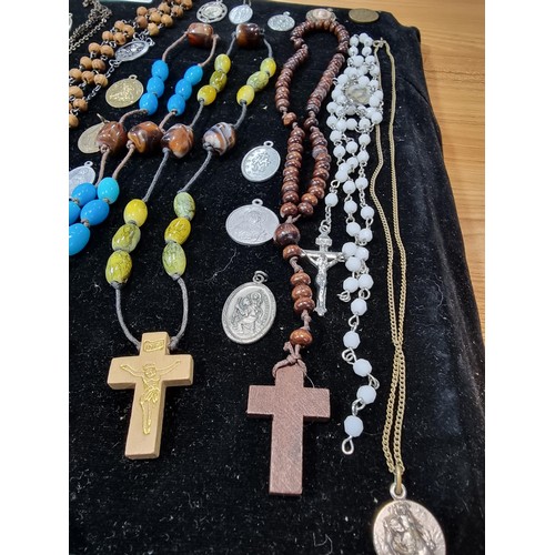 284 - A suite of various religious related jewellery to include many Crucifix's and crosses some with Rosa... 