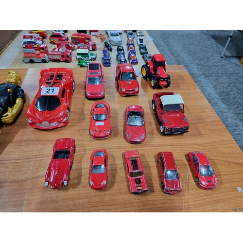 21 - A collection of 12 red die-cast cars to include a red Britain's Land Rover, a Burago, Ferrari 250 te... 