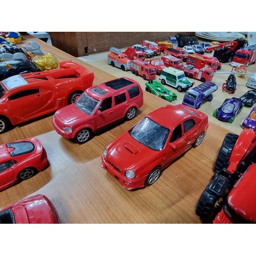 21 - A collection of 12 red die-cast cars to include a red Britain's Land Rover, a Burago, Ferrari 250 te... 