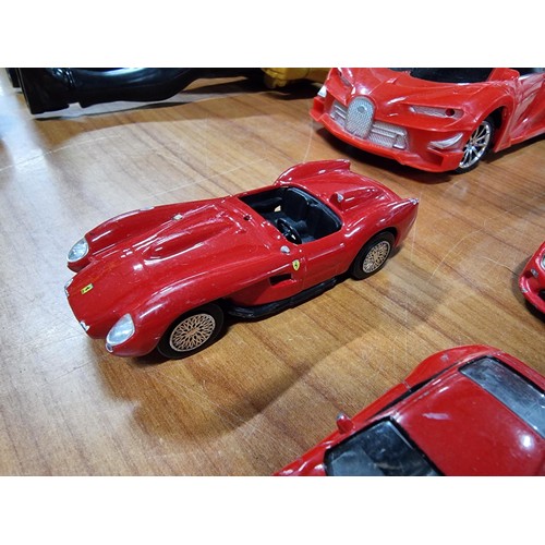 21 - A collection of 12 red die-cast cars to include a red Britain's Land Rover, a Burago, Ferrari 250 te... 