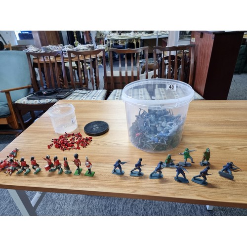 48 - A large collection in 2 tubs of toy soldier figures to include a collection of Britain's Queens guar... 