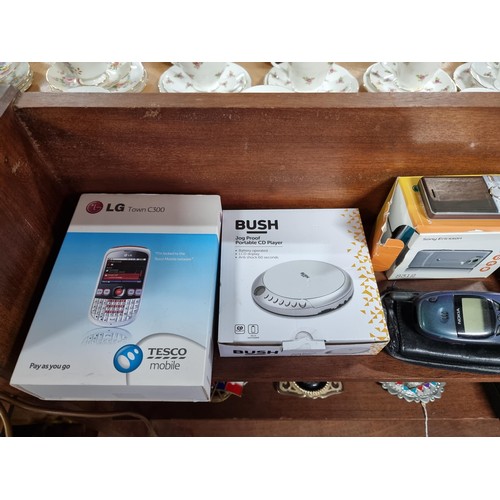 53 - A large collection of vintage mobile phones along with 2 portable CD players, 2x tom tom sat navs, a... 