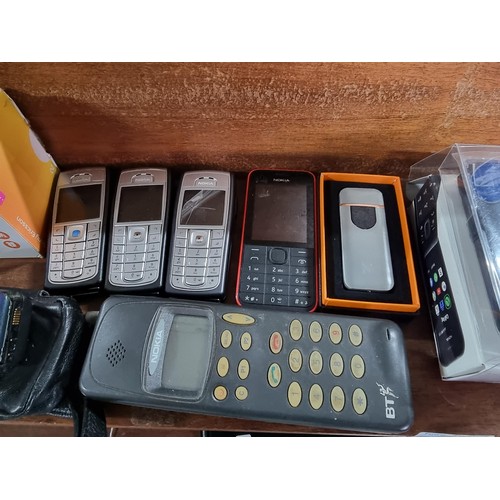 53 - A large collection of vintage mobile phones along with 2 portable CD players, 2x tom tom sat navs, a... 