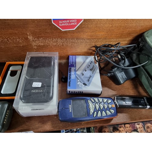 53 - A large collection of vintage mobile phones along with 2 portable CD players, 2x tom tom sat navs, a... 