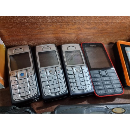 53 - A large collection of vintage mobile phones along with 2 portable CD players, 2x tom tom sat navs, a... 