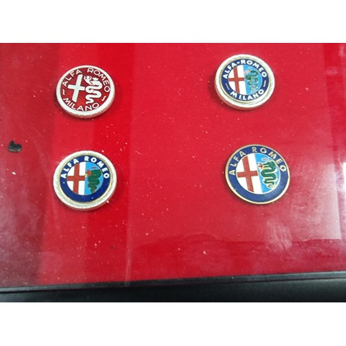 55 - A cased set of 9 Alpha Romeo enamelled pin badges, a very rare and expensive set to purchase when ne... 