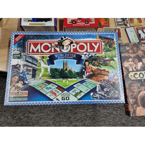 56 - A quantity of collectables to include 2 diecast cars, a Monopoly Worcester edition board game, Coron... 