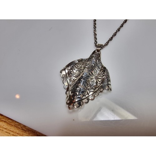 178 - Unusual 925 silver pendant featuring a pierced crinkle floral design set on a long 20