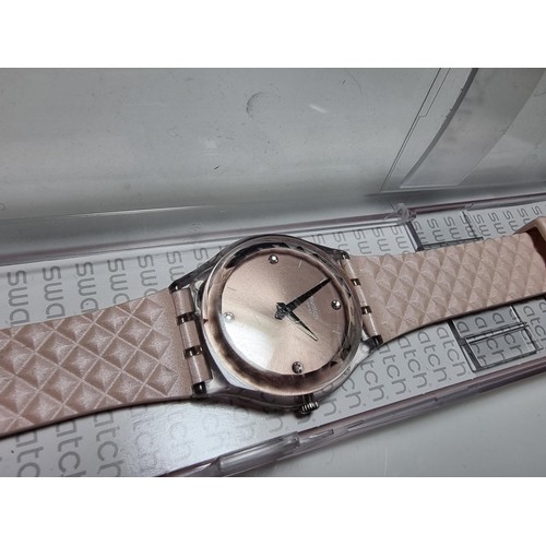 179 - Ladies Swatch wristwatch in a light pink / copper colour, fitted in its original Swatch case. In goo... 