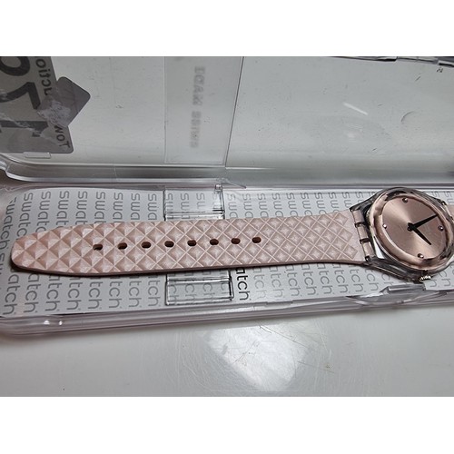 179 - Ladies Swatch wristwatch in a light pink / copper colour, fitted in its original Swatch case. In goo... 