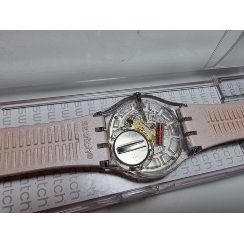 179 - Ladies Swatch wristwatch in a light pink / copper colour, fitted in its original Swatch case. In goo... 