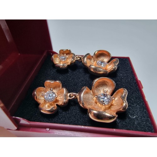 185 - Pair of good quality rose gold plate on solid 925 silver drop earrings each having a two flower desi... 