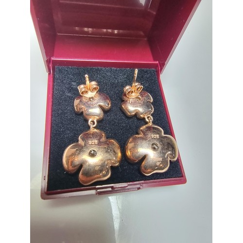 185 - Pair of good quality rose gold plate on solid 925 silver drop earrings each having a two flower desi... 