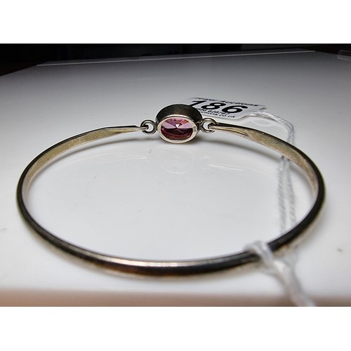 186 - Good 925 silver bangle inset with a large pink oval CZ crystal stone which is sparkly and lively, In... 