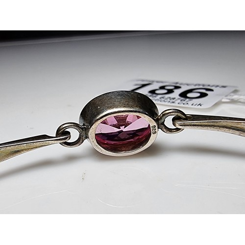 186 - Good 925 silver bangle inset with a large pink oval CZ crystal stone which is sparkly and lively, In... 