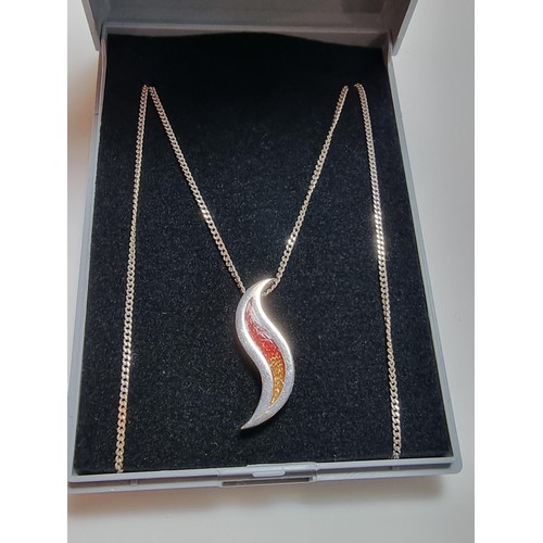 190 - Unusual 925 silver pendant in the form of a flame, with red and yellow enamel inserts. Set on a long... 