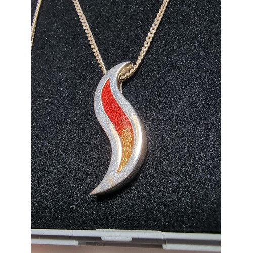 190 - Unusual 925 silver pendant in the form of a flame, with red and yellow enamel inserts. Set on a long... 